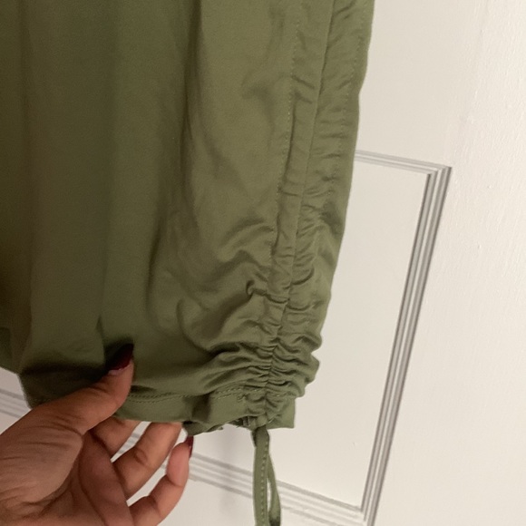 We have a pretty green dress. Super stretchy. Has a butterfly on the front 🦋 - Picture 2 of 3